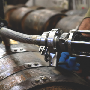 A wooden barrel of beer being tapped"